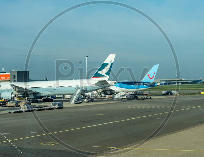 Schiphol, Amsterdam, Netherlands - 4 November 2018 : Tui And Cathay Pacific Planes Waiting At The Airport Dock