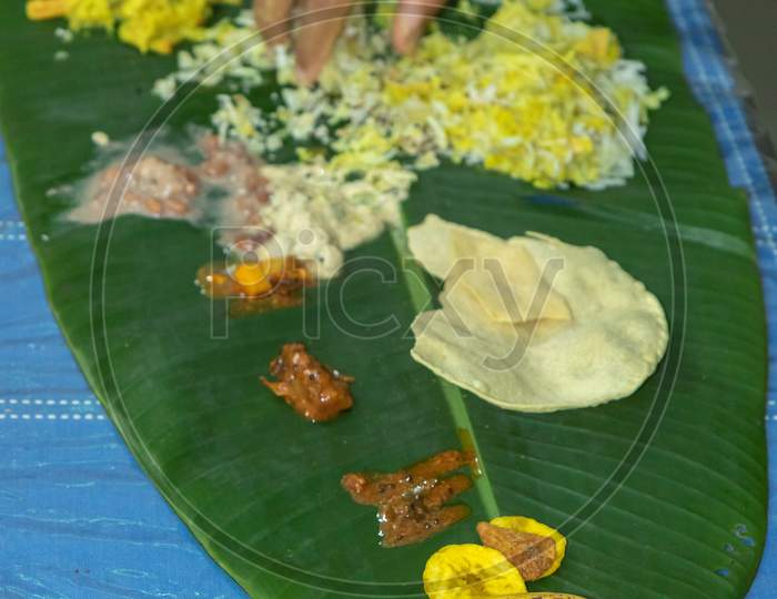 Traditional Kerala food being eaten on a banana leaf