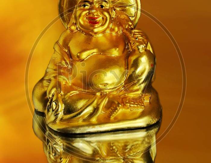Laughing buddha idol reflection