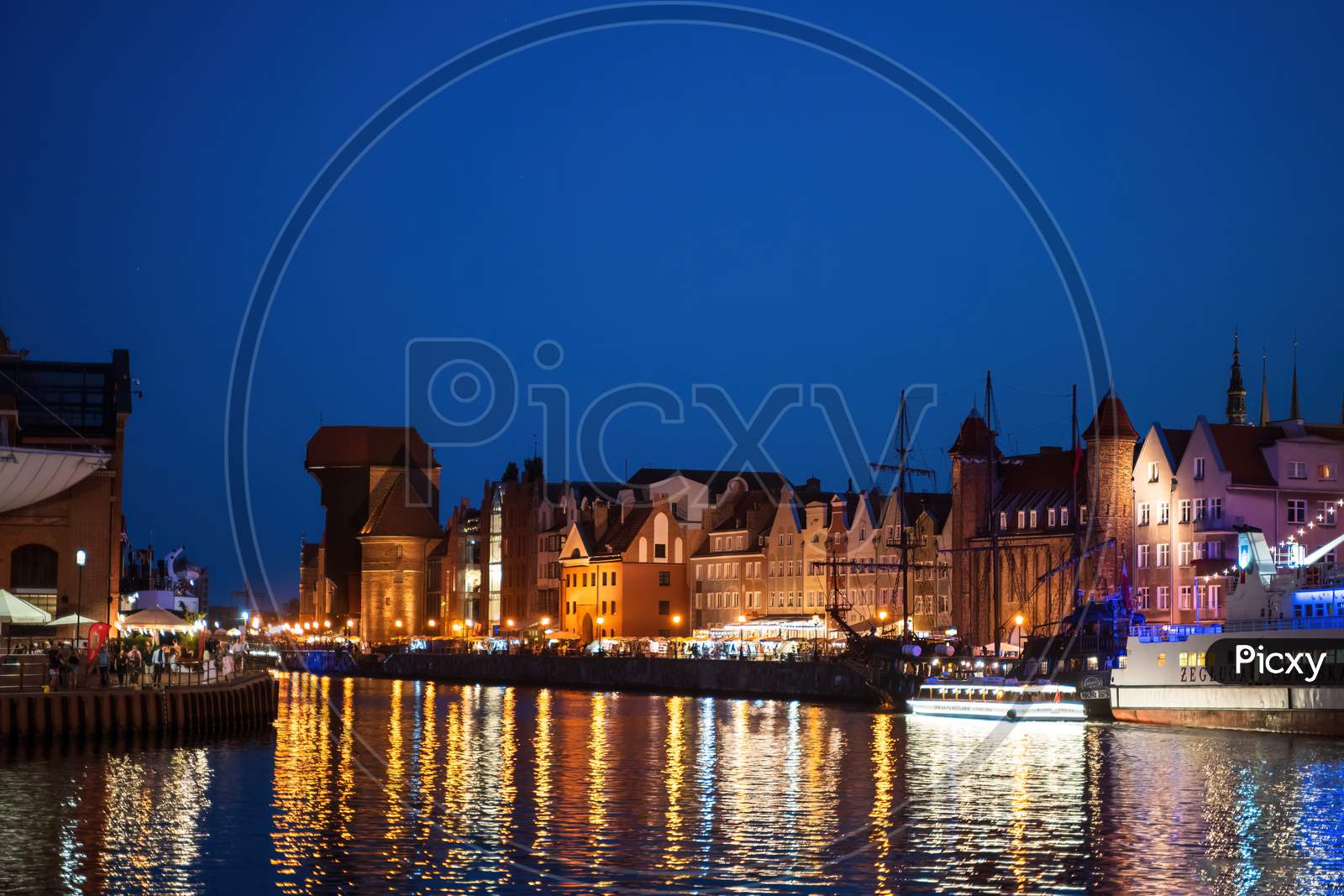 Gdansk, North Poland - August 15, 2020: Wide Angle Night Photography Of Polish Cityscape Over Motlawa River Near Baltic Sea
