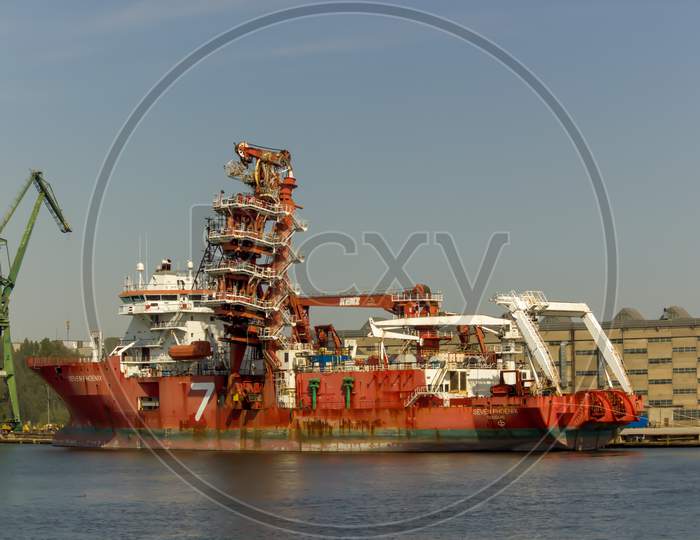 Gdansk, North Poland - August 15, 2020: A Big Ship With Cranes Portraying Industrial Side Of City Next To Motlawa River
