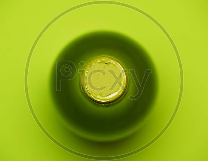 Top View Of Green Wine Bottle On Green Background. Flat Lay