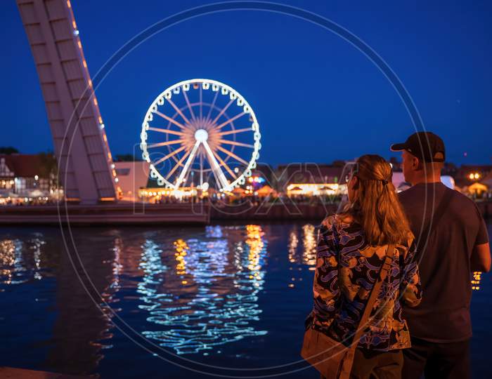 Gdansk, North Poland - August 13, 2020: A Couple Male And Female Looking At The Cityscape Over Motlawa River At City Center Main Square
