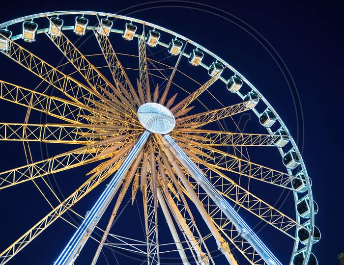 Closeup View Of Illuminated Ferries Wheel Against Night Sky Located Over Motlawa River