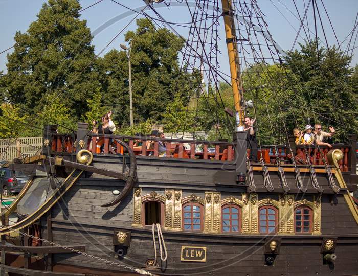 Gdansk, North Poland - August 15, 2020: Close Up Of Pirate Ship And Passenger Waving At Other Ship Sailing Over Motlawa River After Masks Were Not Mandatory To Wear Outdoors During Covid Time