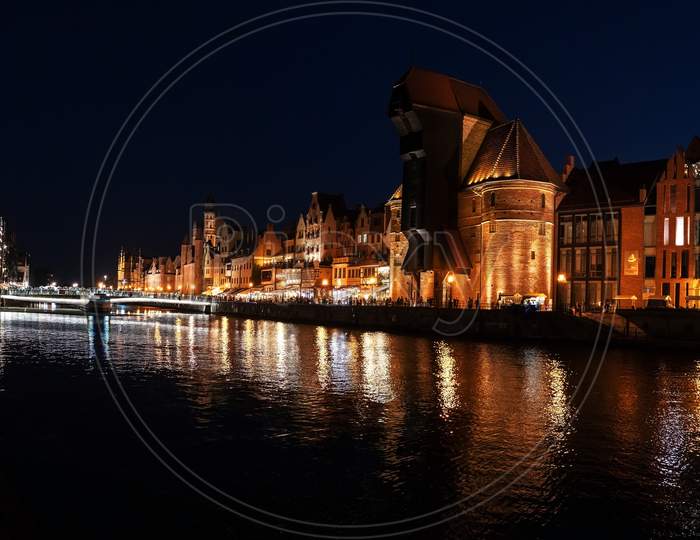 Gdansk, North Poland - August 15, 2020: Wide Angle Panoramic Night Photography Of Polish Cityscape With Polish Architecture In The Old Town Over Motlawa River Near Baltic Sea