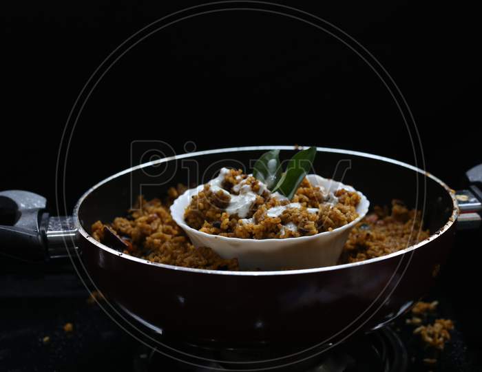 Puliyogare Rice In The Cooking Pan With Bowl, Yellow Color Indian Rice