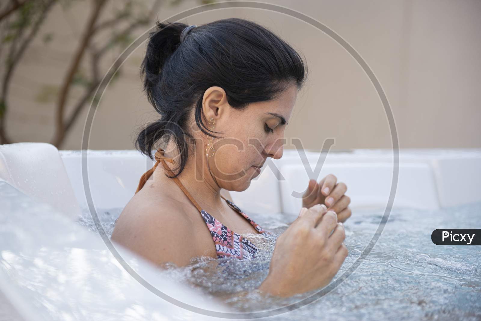 Side View Of Young Beautiful Woman Relaxing And Enjoying In A Hydromassage Bath.