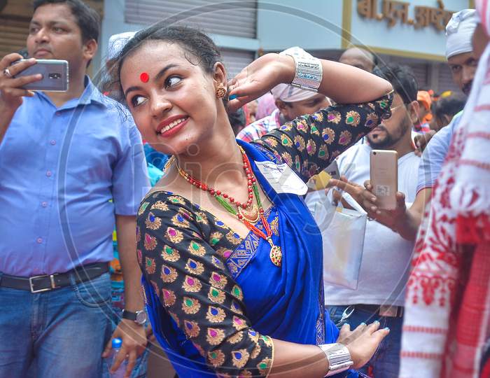 Pune, India - September 4, 2017: Assamese Women Wearing Traditional Saree And Jewellery Doing Folk Dance On The Crowded Streets Of Pune On The Occasion Of Ganpati Visarjan Festival.