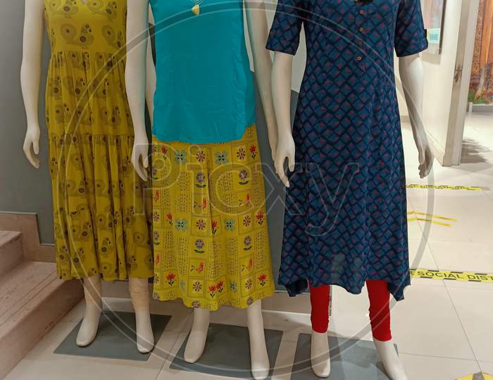 An Charming picture of three mannequins wearing colorful Indian cotton outfits in a fashion store in Mysuru/Karnataka state of India.