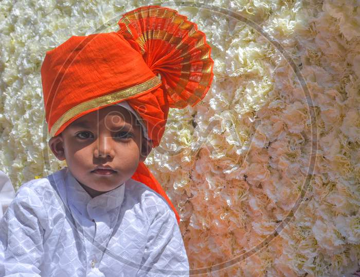 Pune, India - September 4, 2017: Landscape Portrait Of A Small Kid Wearing White Kurta And Orange Pheta On The Occasion Of Ganpati Visarjan Festival.