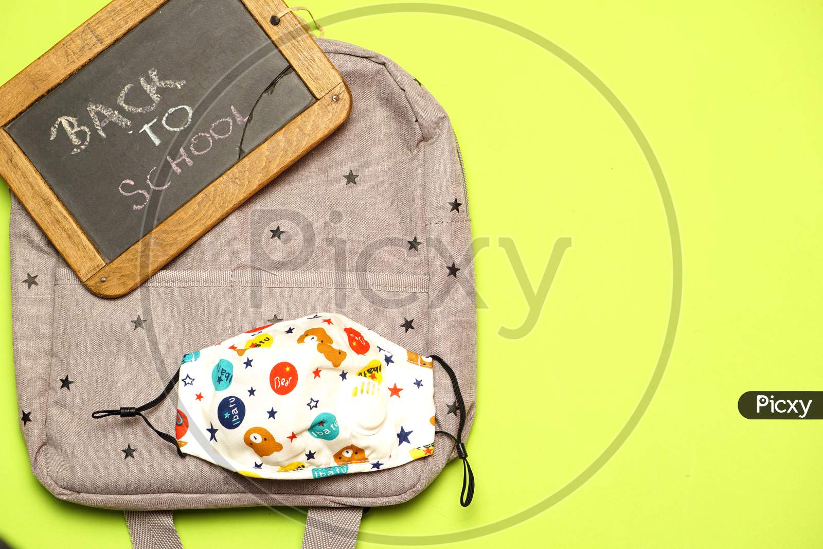 Top View Of Blackboard With Back To School Message On Backpack And Boy Or Girl Mask. Covid 19. Flat Lay Flat Design