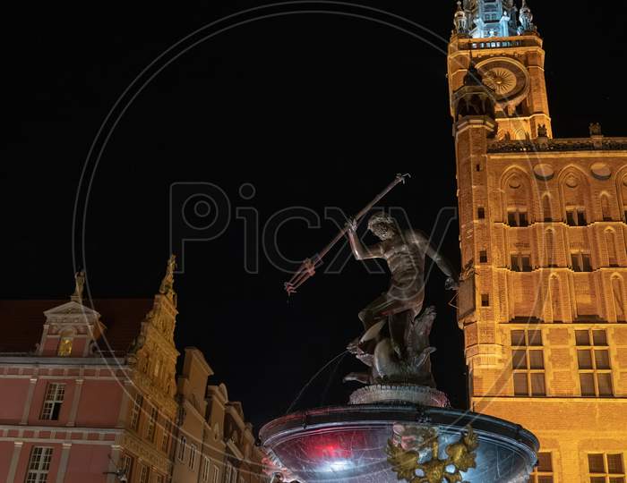 Gdansk, North Poland - August 15, 2020: Wide Angle Shot Of Famous Touristic Attraction Of Neptune'S Fountain Located At The City Center Main Square Of Old Town