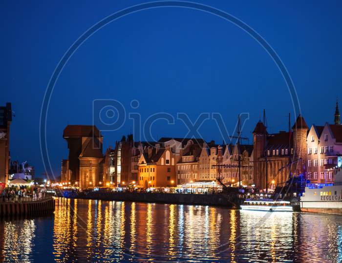 Gdansk, North Poland - August 15, 2020: Wide Angle Night Photography Of Polish Cityscape Over Motlawa River Near Baltic Sea