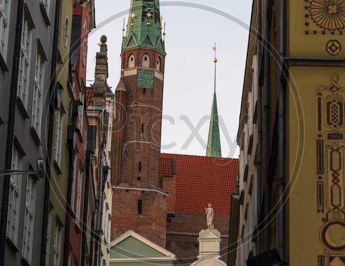 Gdansk, North Poland - August 15, 2020: Narrow Passage Through Polish Architecture Building In The City Center Old Town Containing Famous Church