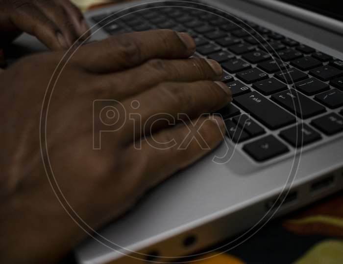 Man Press Black Key On Keyboard In Gray Color Laptop.Close Up Laptop Keyboard With Touch Pad.Hand Writing Or Typing On Keyboard.Man Using A Laptop On Bed. Chatting Concept.