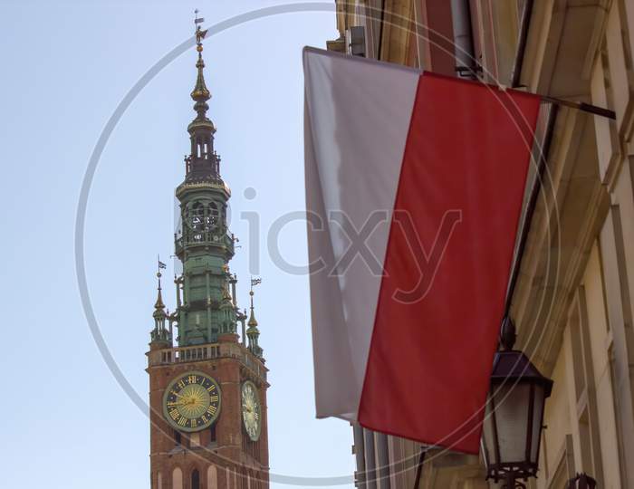 Gdansk, North Poland - August 15, 2020: A Polish Flag In Front Of Famous St Mary Church