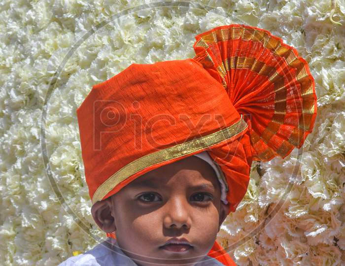 Pune, India - September 4, 2017: Vertical Portrait Of A Small Kid Wearing White Kurta And Orange Pheta On The Occasion Of Ganpati Visarjan Festival. Maharashtrian/Marathi Kid In Traditional Clothes.