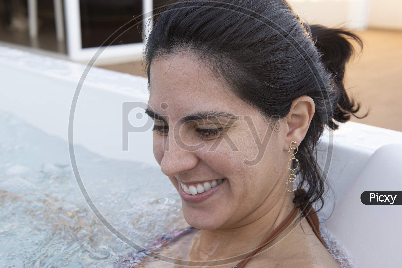 Beautiful Woman Smiling Wearing Bikini In A Hydromassage Bath.