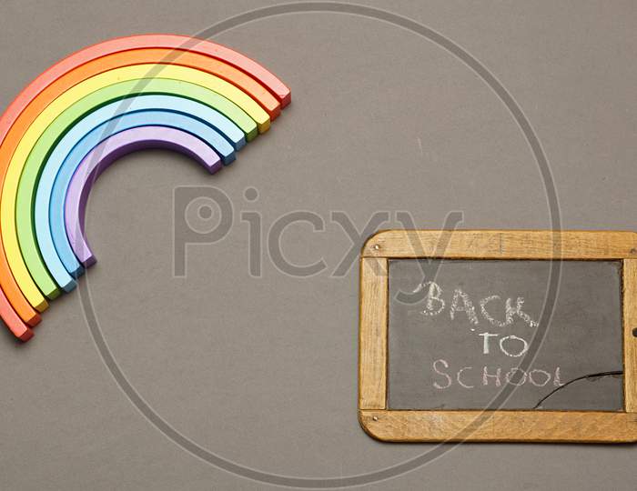 Top View Of Blackboard With Back To School Message And Rainbow. Covid 19. Flat Lay