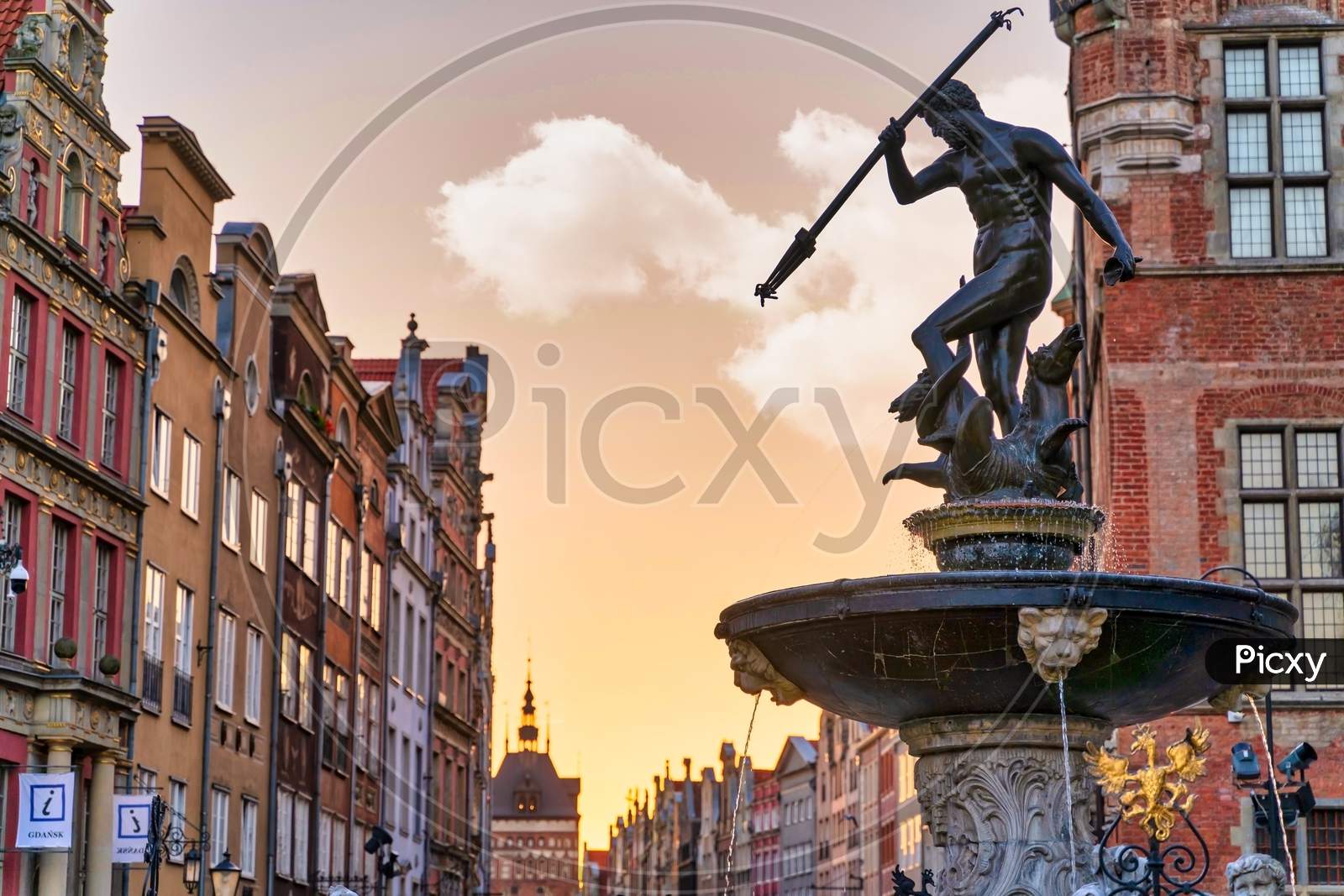 Gdansk, North Poland - August 15, 2020: Wide Angle Shot Of Famous Touristic Attraction Of Neptune'S Fountain Located At The City Center Main Square Of Old Town Against Dramatic Sky