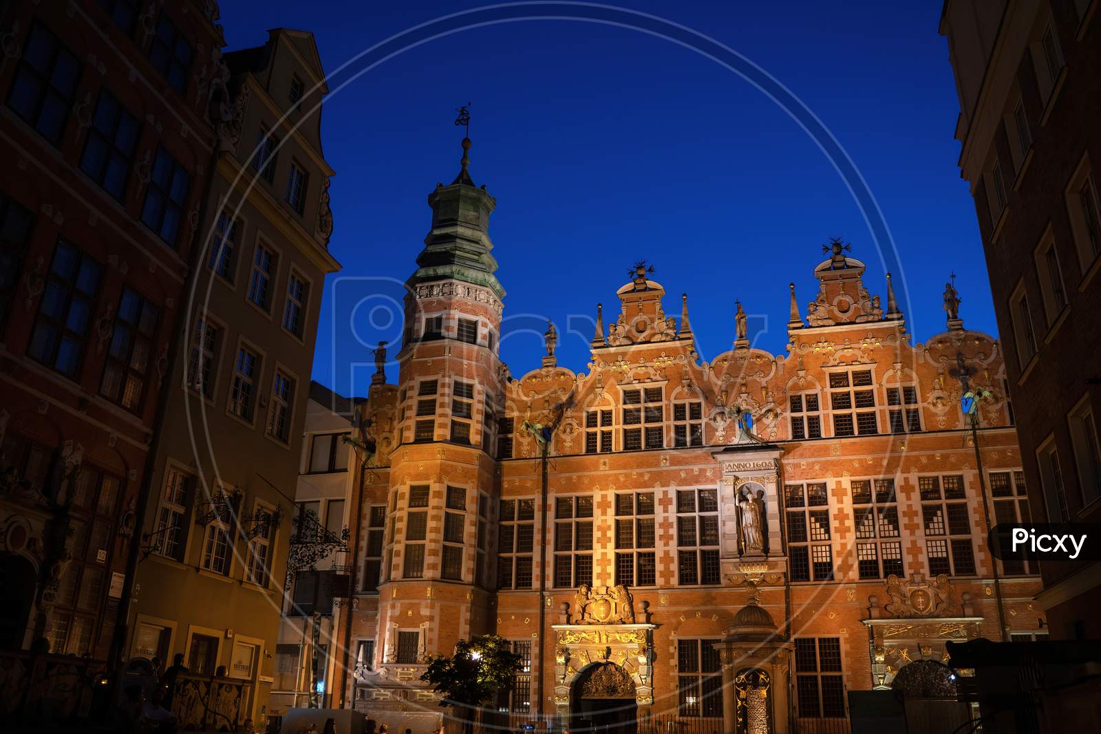 Gdansk, North Poland - August 13, 2020: Wide Angle Night Shot Of A Long Lane Street In Old Town Displaying Polish Architecture Against Clear Blue Night Sky