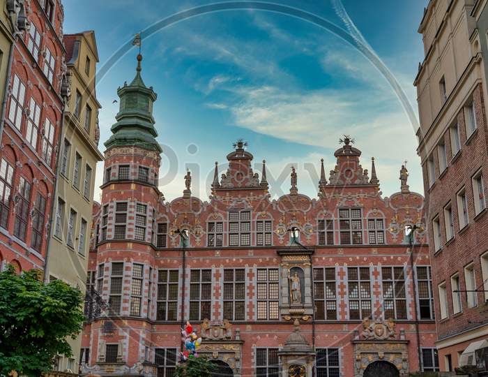 Gdansk, North Poland - August 13, 2020: Wide Angle Shot Of A Long Lane Street In Old Town Displaying Polish Architecture Against Blue Sky