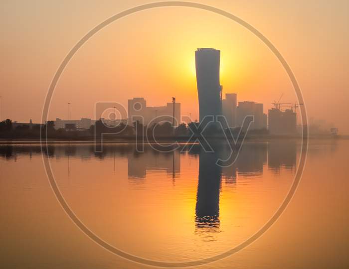 Sunrise Sky View Background Behind Capital Gate Tower Of Abu Dhabi, Skyscrapers In Capital City Of United Arab Emirates