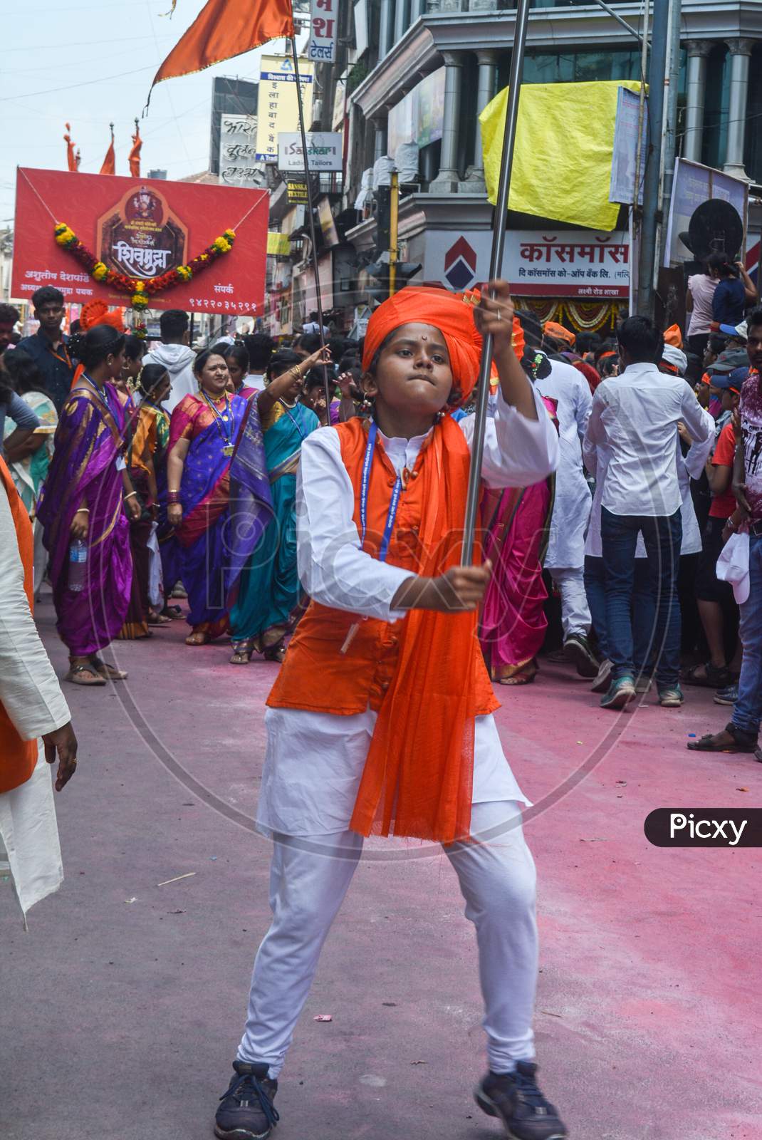 Pune, India - September 4, 2017: A Small Girl Looking Aggressive And Is Passionately Dancing With A Flag On The Occasion Of Ganpati Visarjan Festival / Anant Chaturdashi Festival Celebration In Pune.