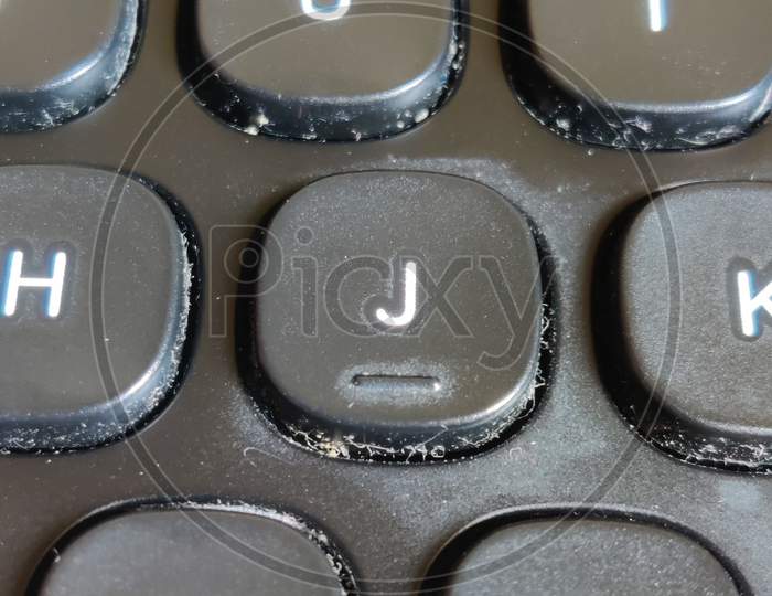 Dirty keyboard showing particles in the gap between keys