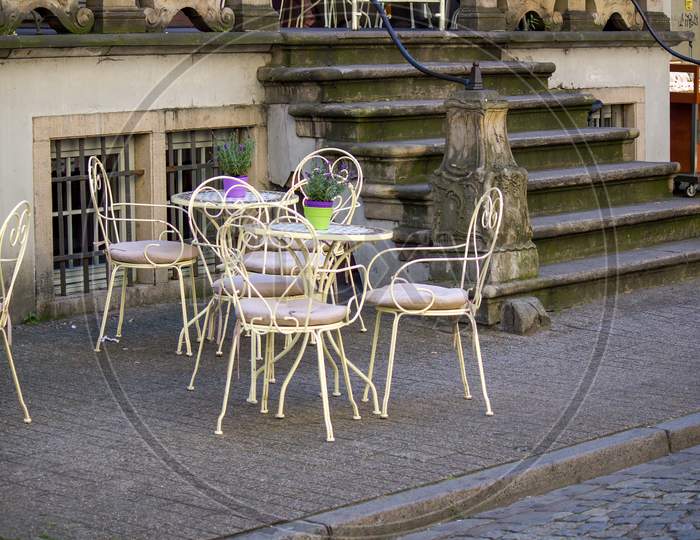 Gdansk, North Poland - August 15, 2020: Medieval Style Chair And Table Kept Outside Of Restaurant Located In The City Center Main Square In The Famous Old Town