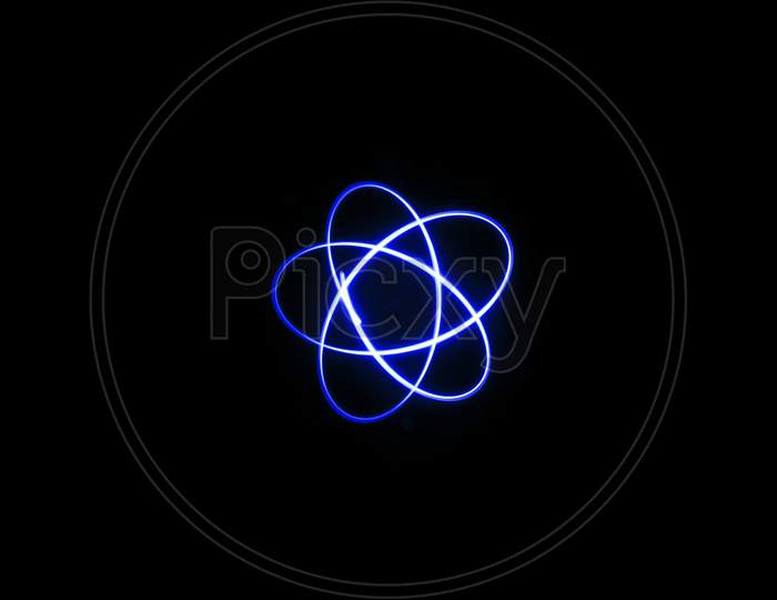 Three Blue Orbit Circle Mixed Light Painting Photography, Long Exposure, Ripples And Waves Against A Black Background