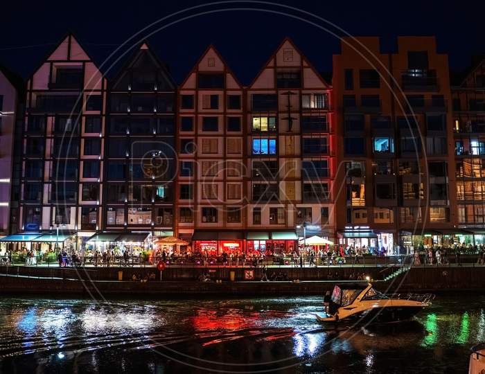 Gdansk, North Poland - August 13, 2020: Night Photograph Of Medieval Style Polish Architecture Over Motlawa River Located In The Old Town Near Baltic Sea
