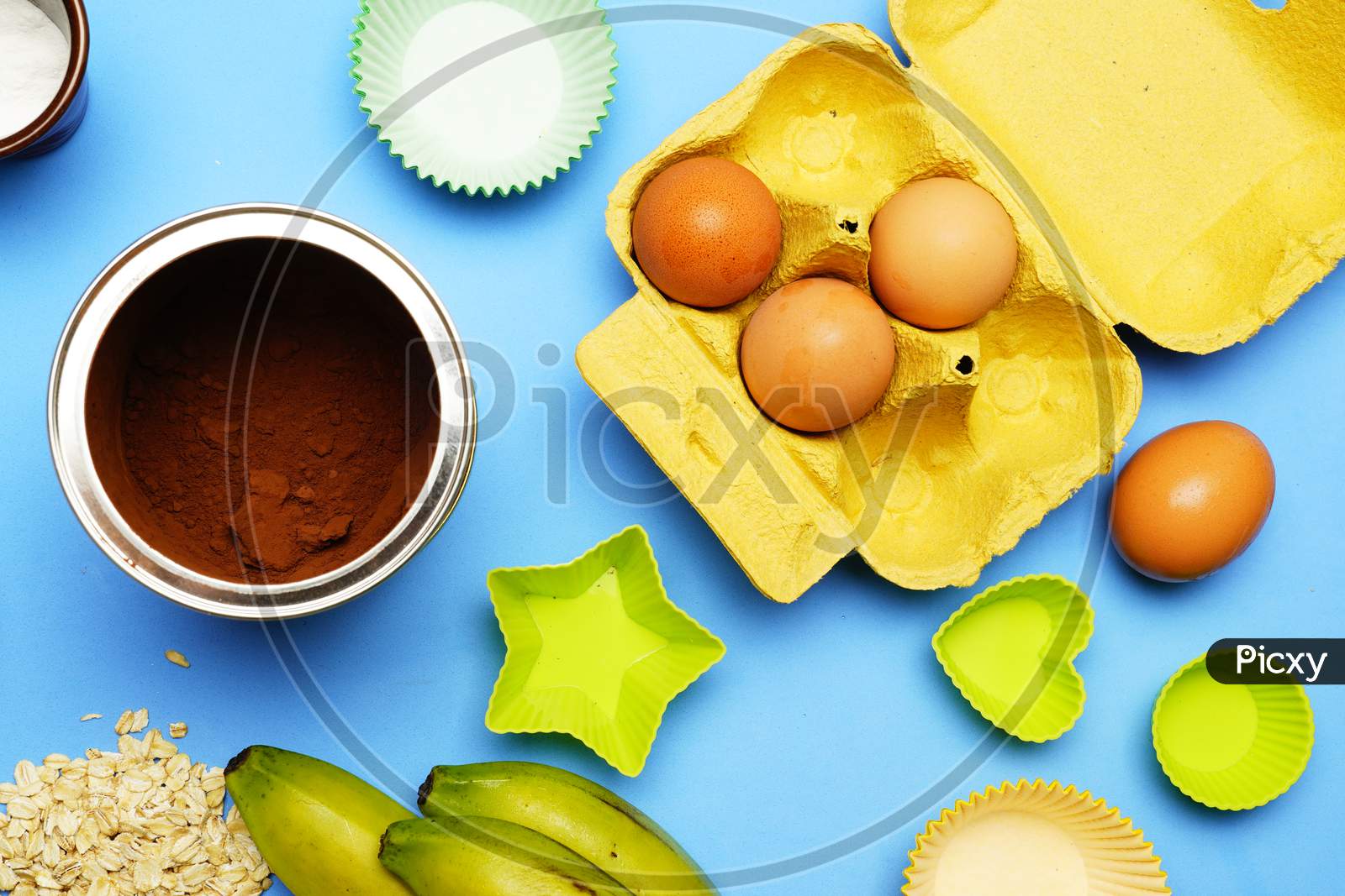 Top View Of Ingredients To Make A Cake With Pastry Mold And Muffins. Flat Lay Flat Design