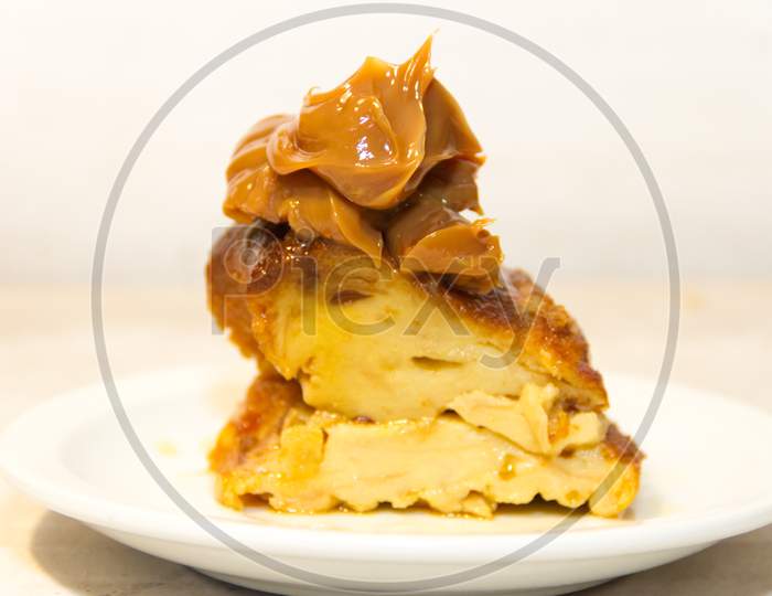 Bread Pudding Made With Stale Bread, Milk, Eggs And Sugar, Decorated With Liquid Caramel And Dulce De Leche