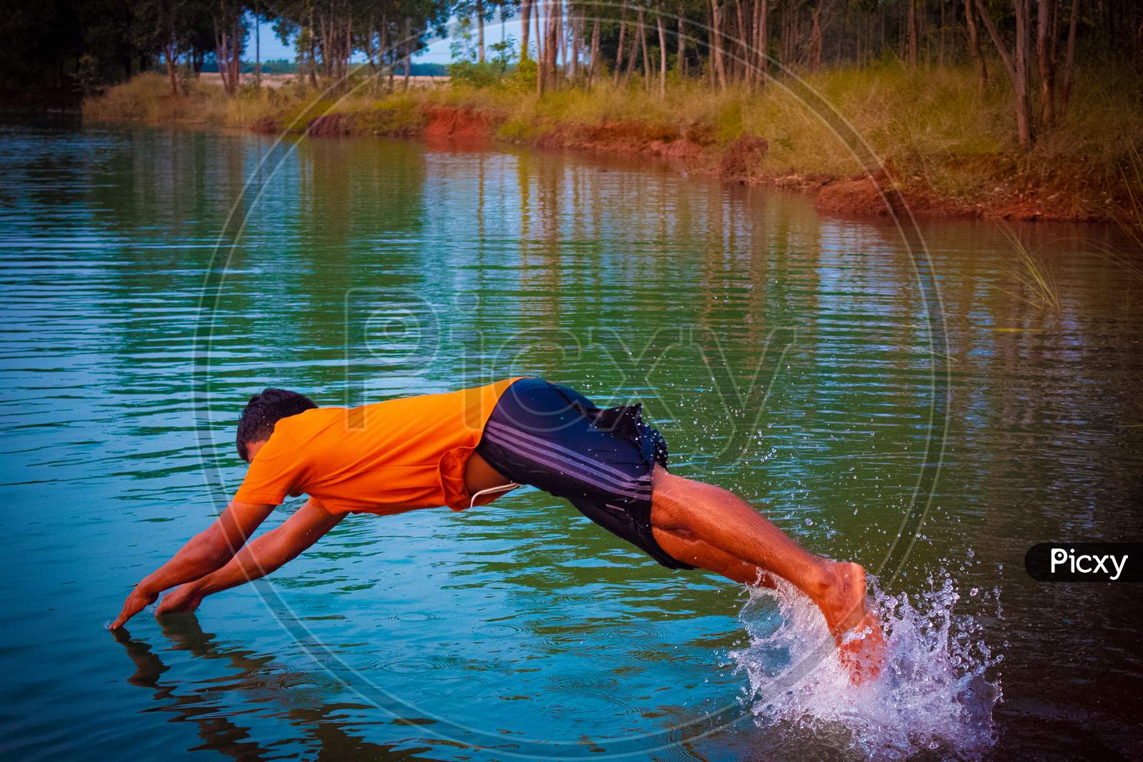 man diving to a water