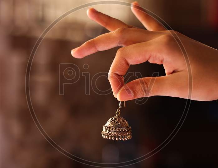 The Ethnic Jhumka Indian Traditional Ear Rings In Girls Hand