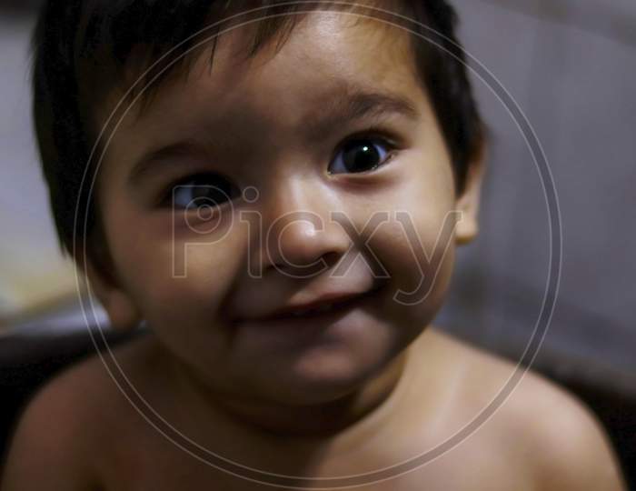 indian cute little boy smiling at camera, soft focus