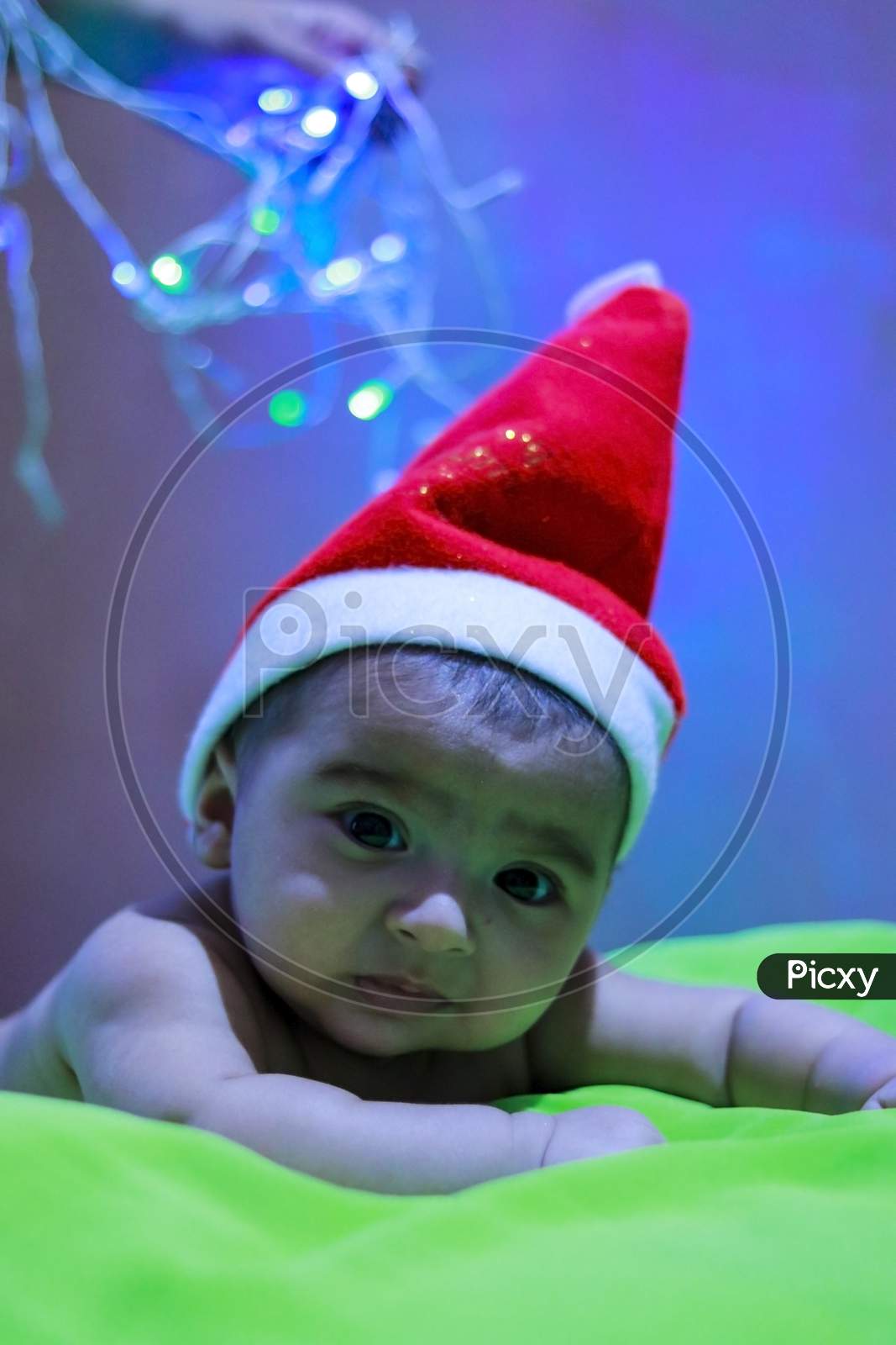 small little baby boy wearing santa claus hat