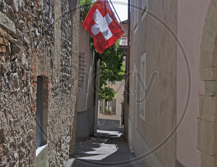 Swiss Flag Hanging In A Village Of Ticino Canton