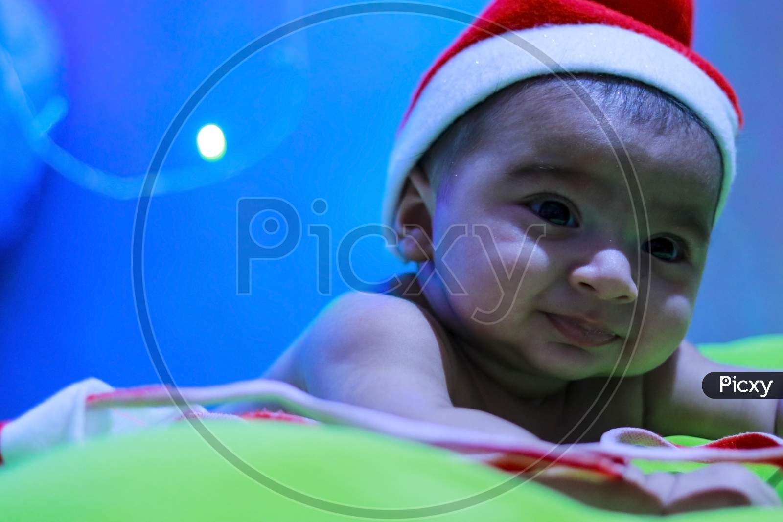 small little baby boy wearing santa claus hat