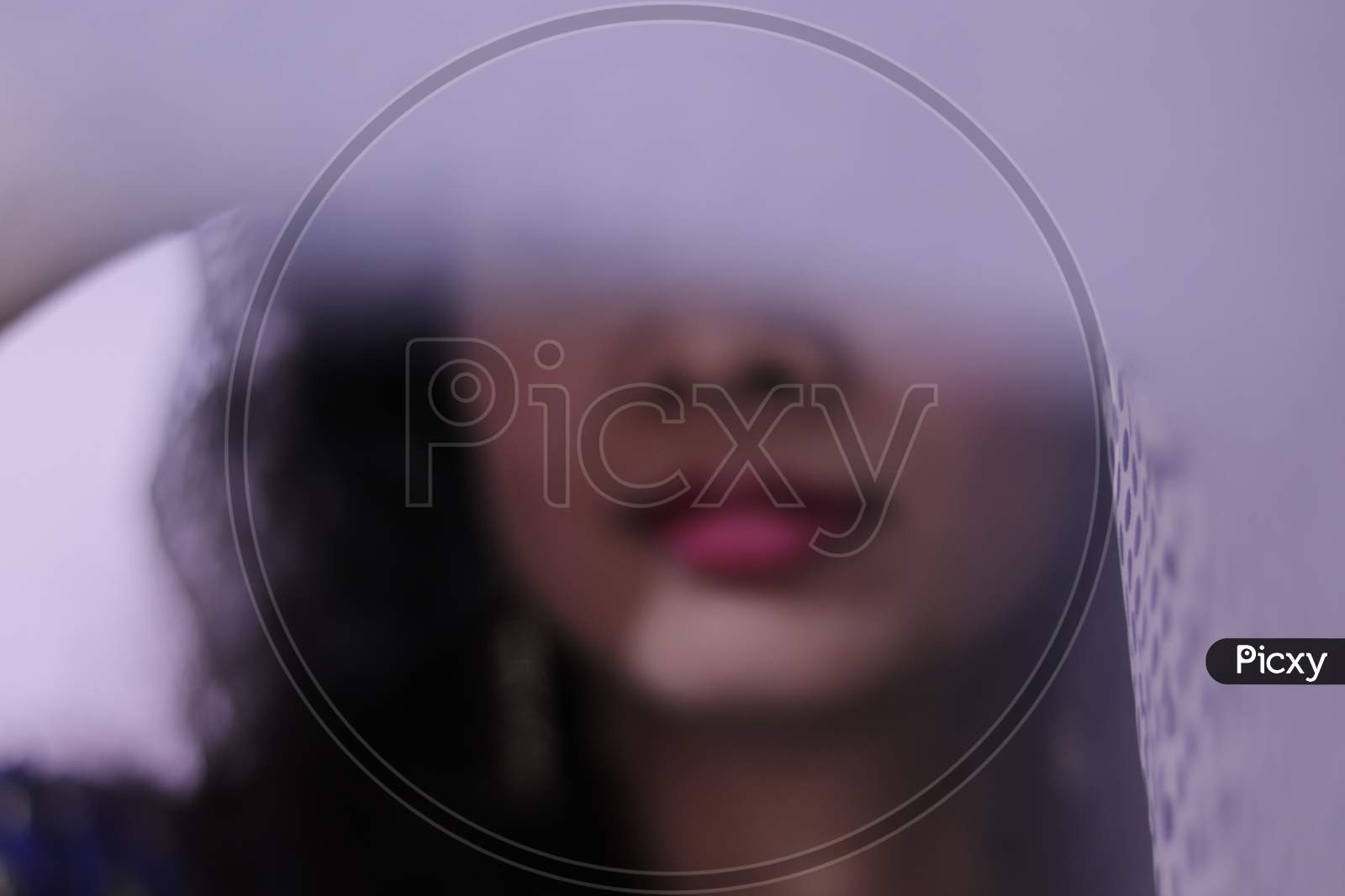 portrait of beautiful indian young woman, covered face with white cloth, selective focus, blurred on purpose