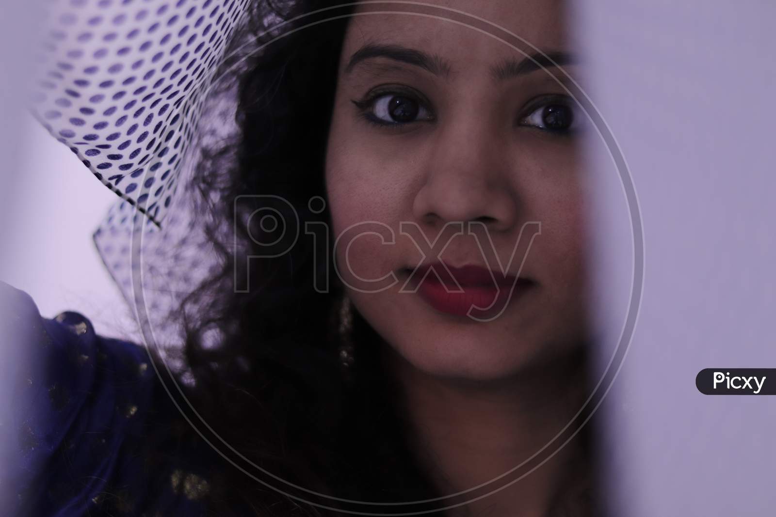 portrait of beautiful indian young woman, covered face with white cloth, selective focus, blurred on purpose