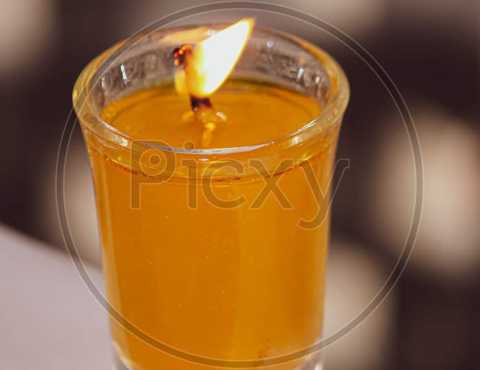 A beautiful glass candle glowing