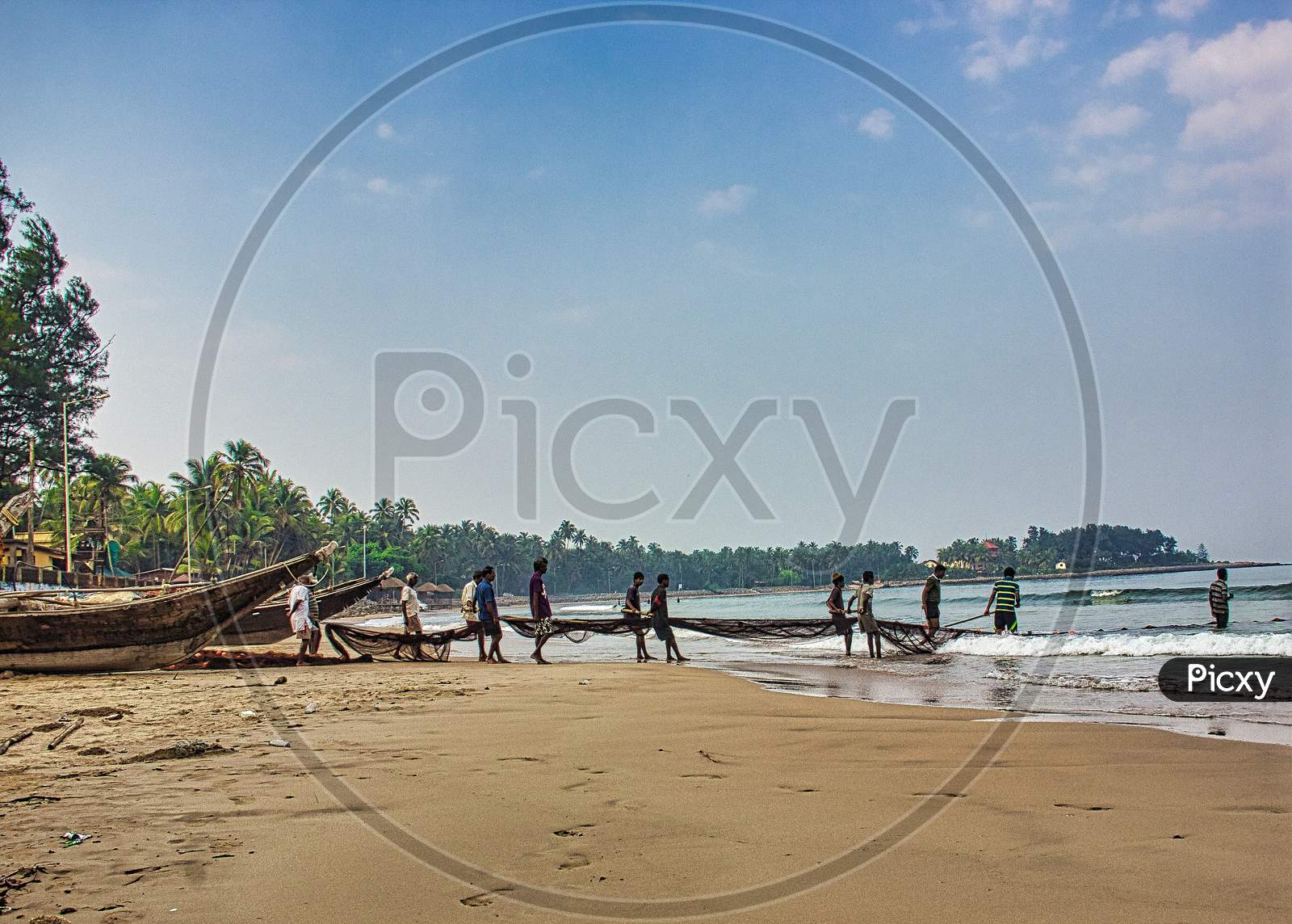 Malvan Sea beach with boat at early morning and fishermen fishing