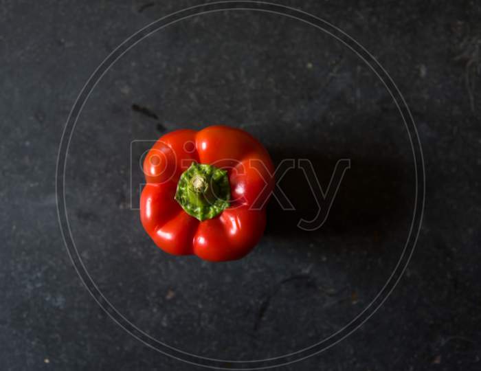 View from above of red bell pepper on a black background