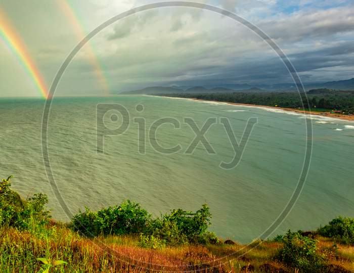 Sea Shore Horizon With Rainbow View From Mountain Top At Morning