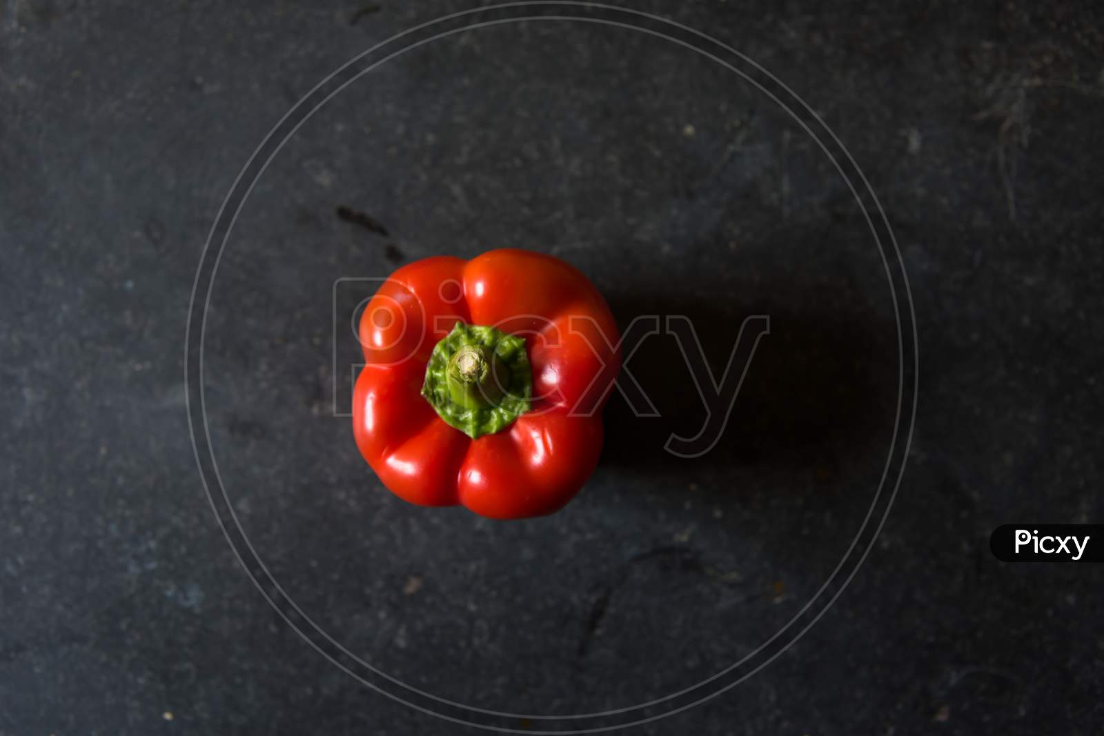 View from above of red bell pepper on a black background