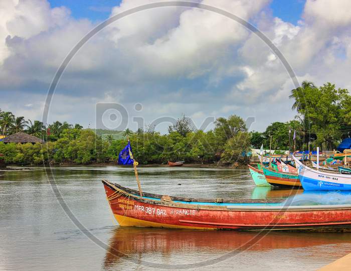 Goa, Boat at the beach with blue sky, village, India
