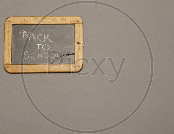Top View Of Blackboard With Back To School Message. Flat Lay Flat Design